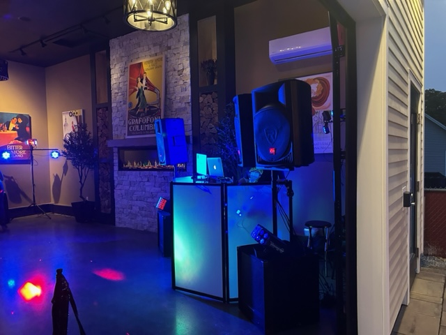 A room with a lot of speakers and lights on the floor.