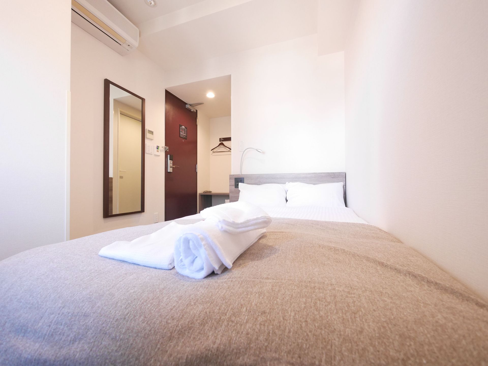 Cozy single room with bed, lamp, and curtains in Tokyo