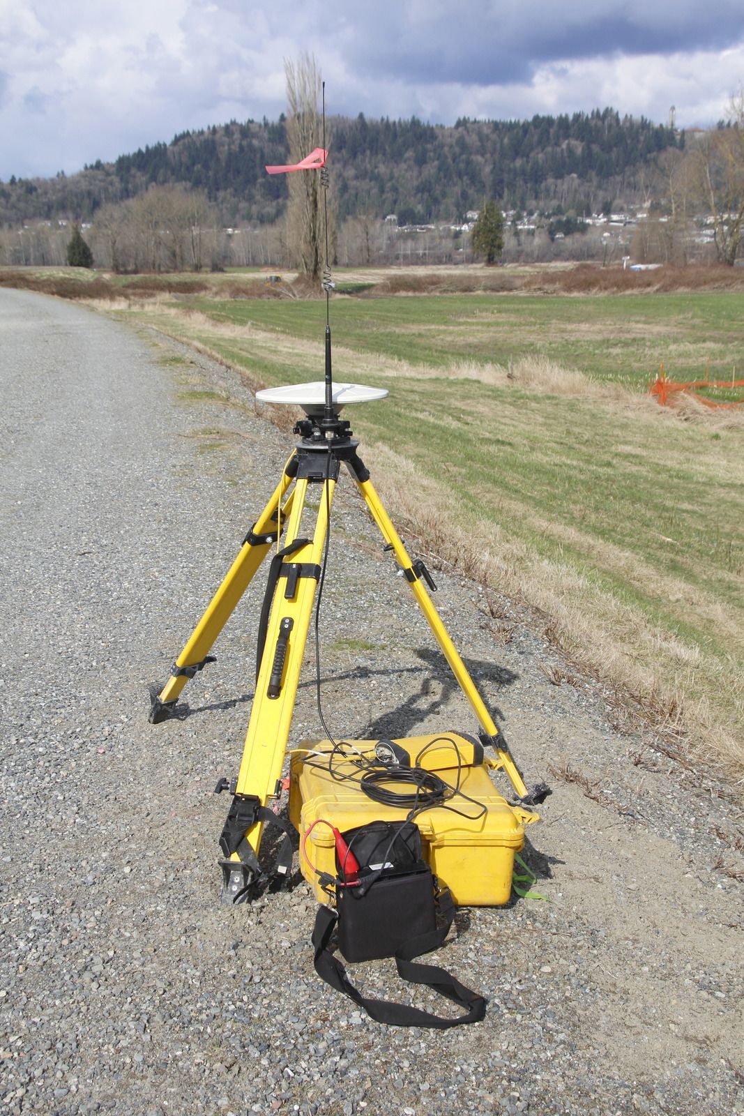 A large house with a garage and a driveway on a rainy day.
