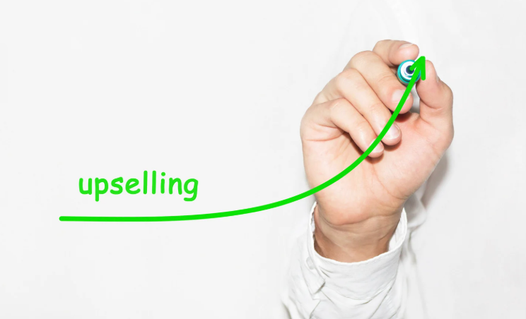 A hand drawing a green upward trending arrow labeled 