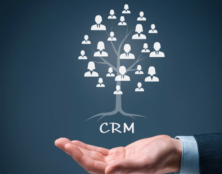 A hand holding a tree-shaped graphic made of people icons, representing CRM. The background is a dark blue gradient.