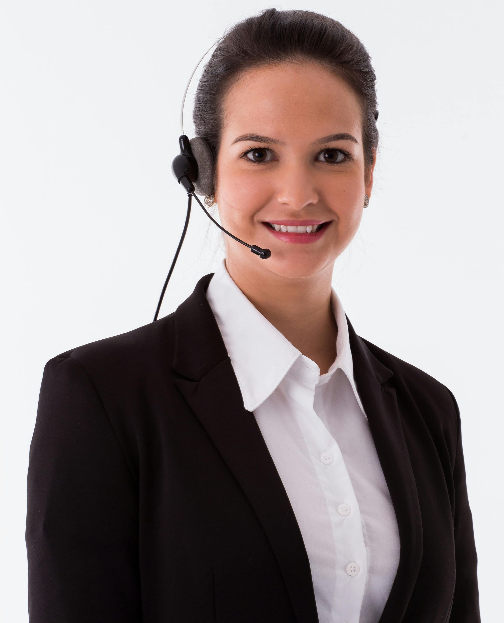 A woman in a black suit and headset smiles, a remote sales representative.