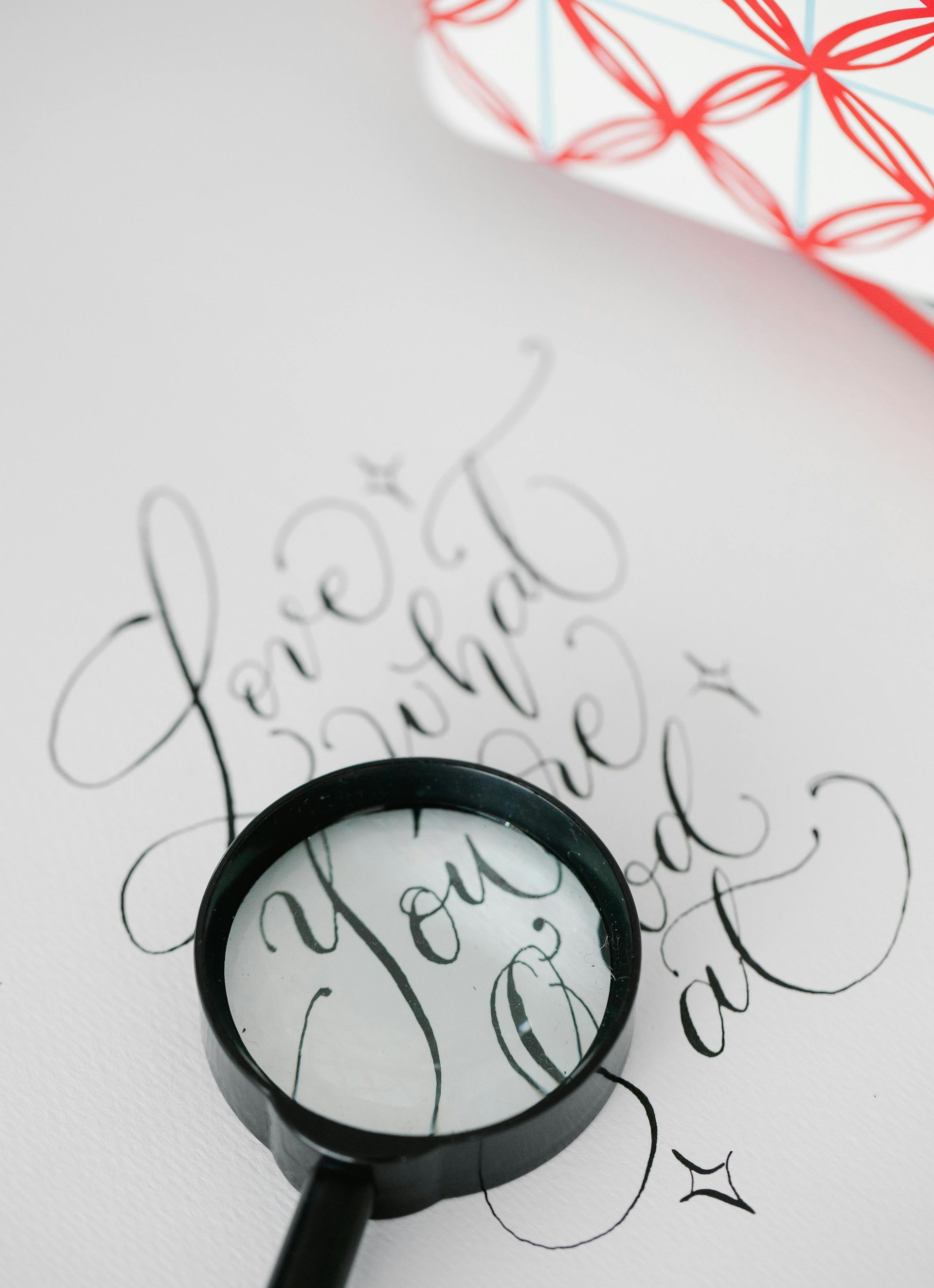 Magnifying glass over cursive lettering 