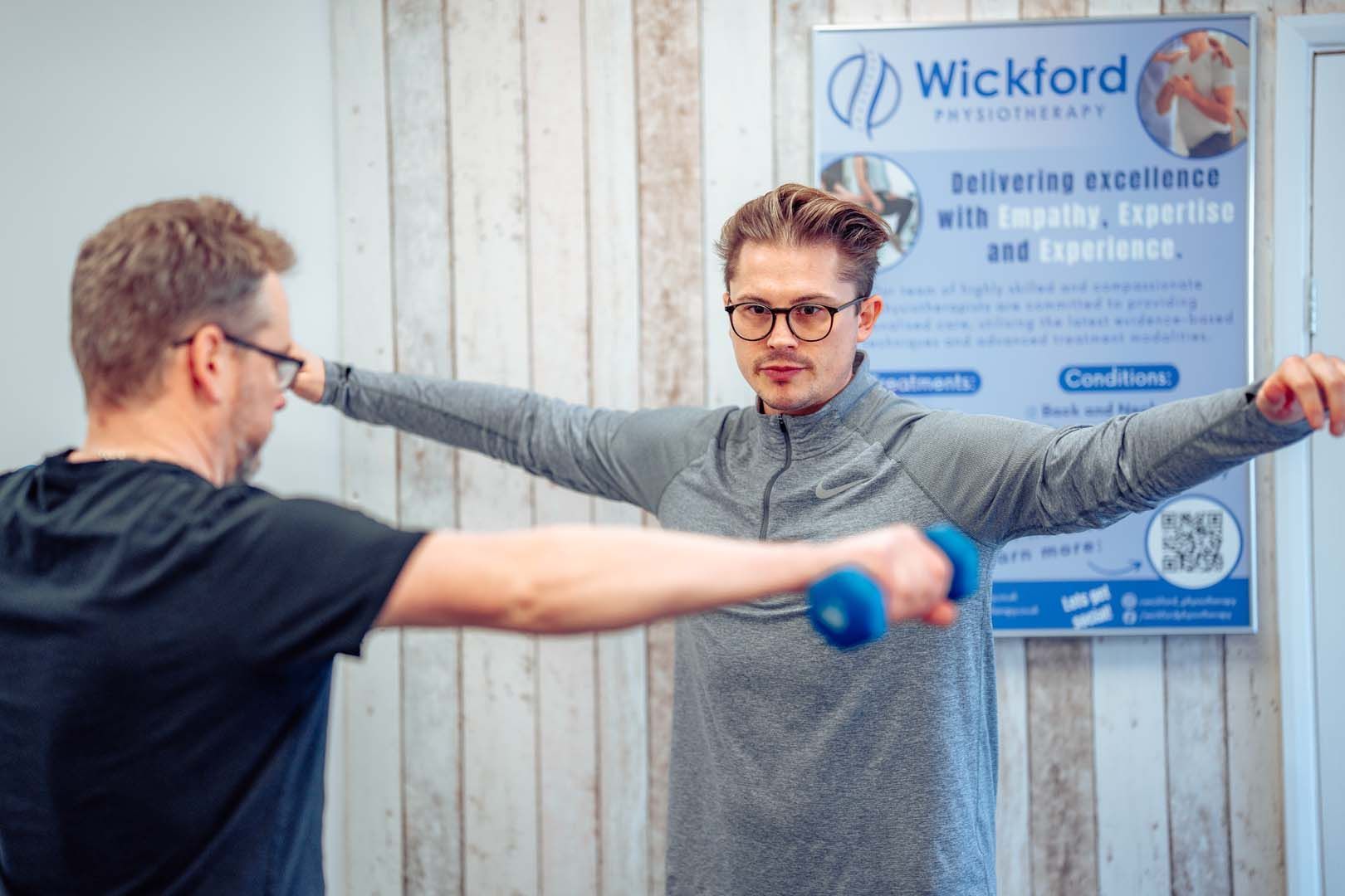 a man is getting a shoulder massage from a doctor .