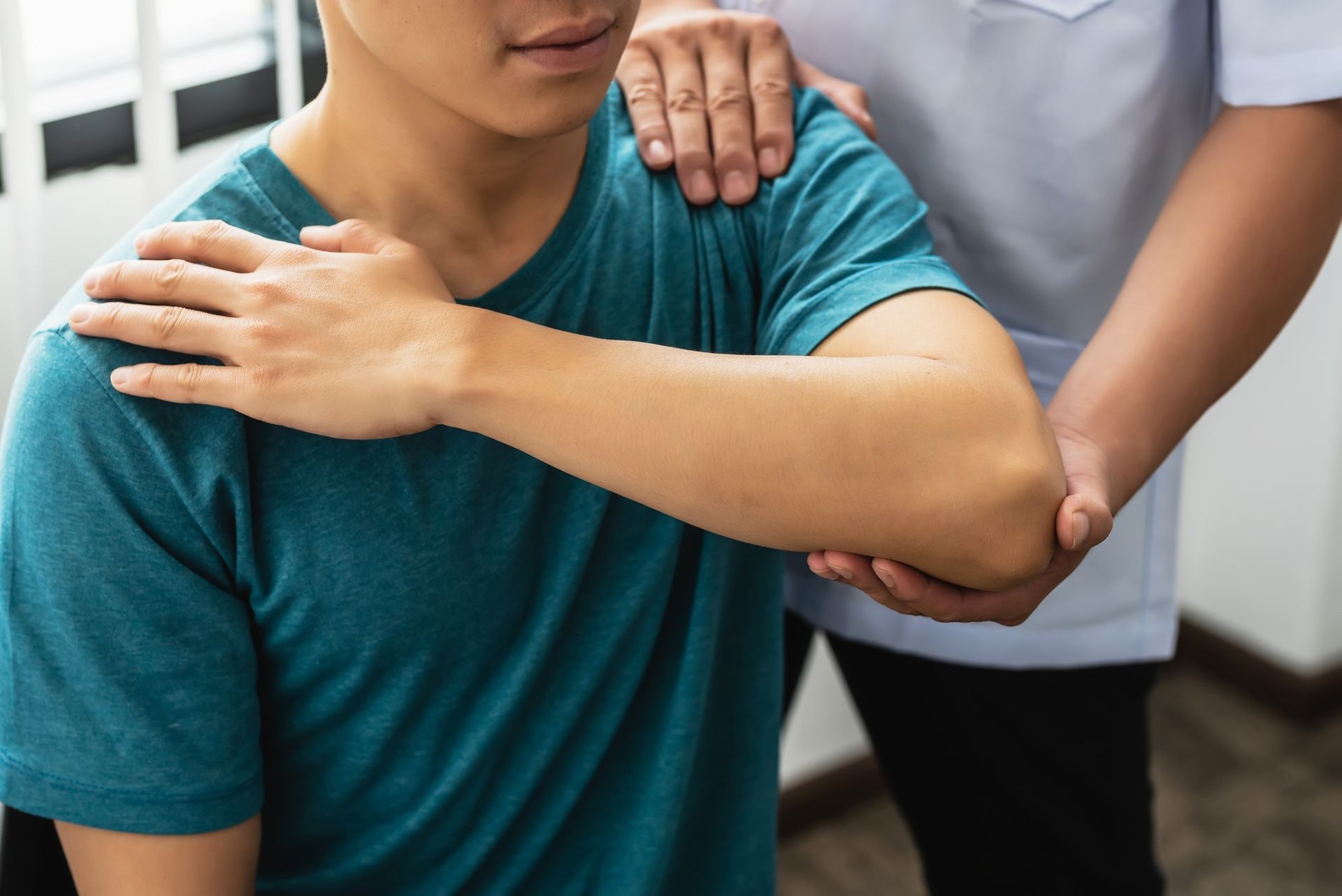 a man is getting a shoulder massage from a doctor .