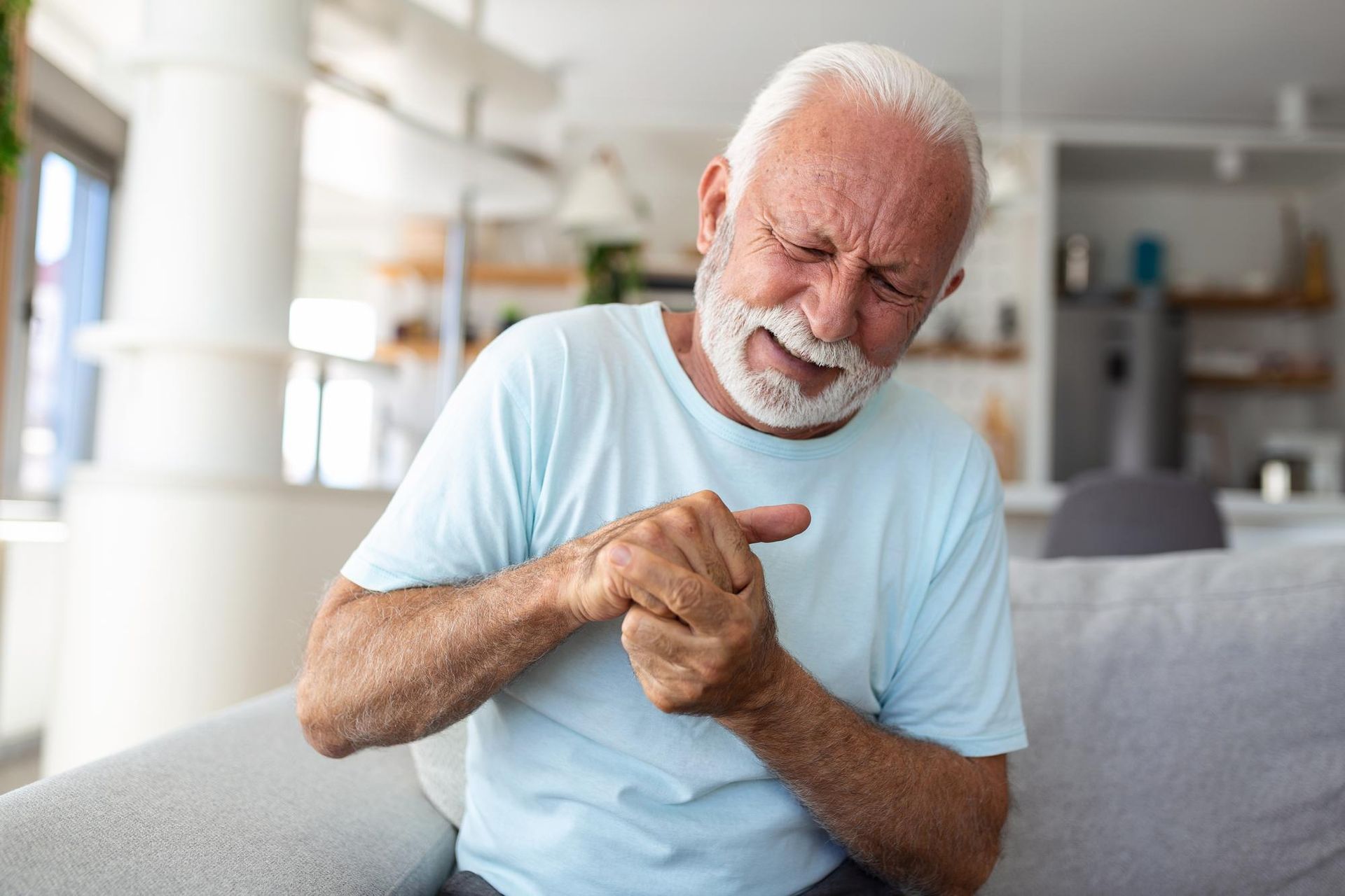 Understanding Osteoarthritis - Wear and Tear Arthritis, man holding hand in pain - joints pain