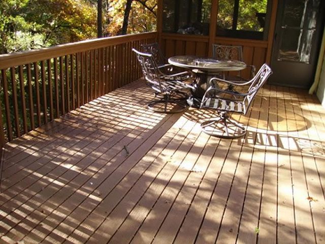 A wooden deck with a table and chairs on it