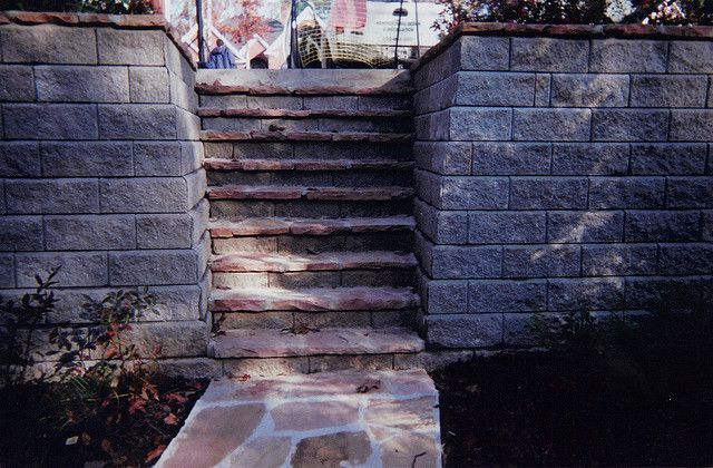 A set of stairs leading up to a stone wall