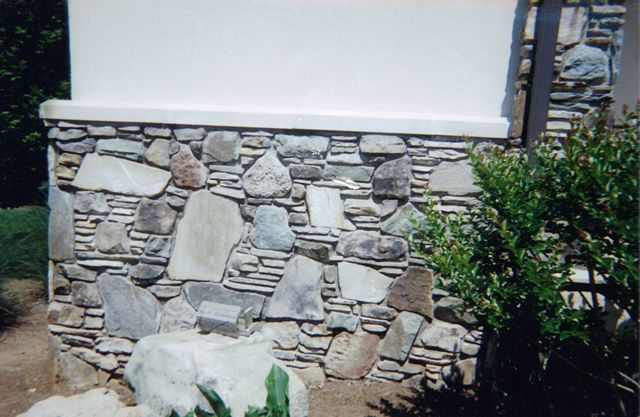 A stone wall on the side of a building