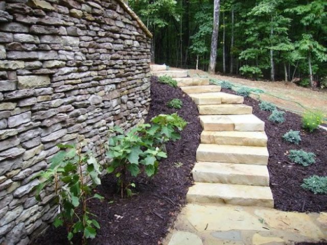 A stone wall with stairs leading up to it