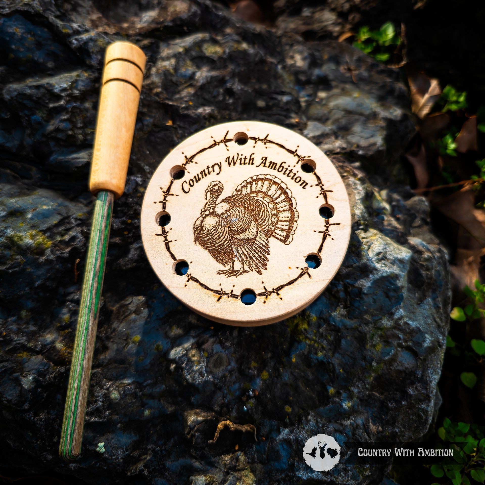 Wooden turkey call on a rock. Call has etched turkey and 