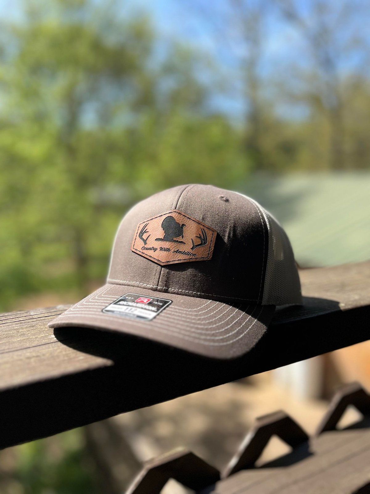 Gray and white Richardson trucker hat with turkey leather patch
