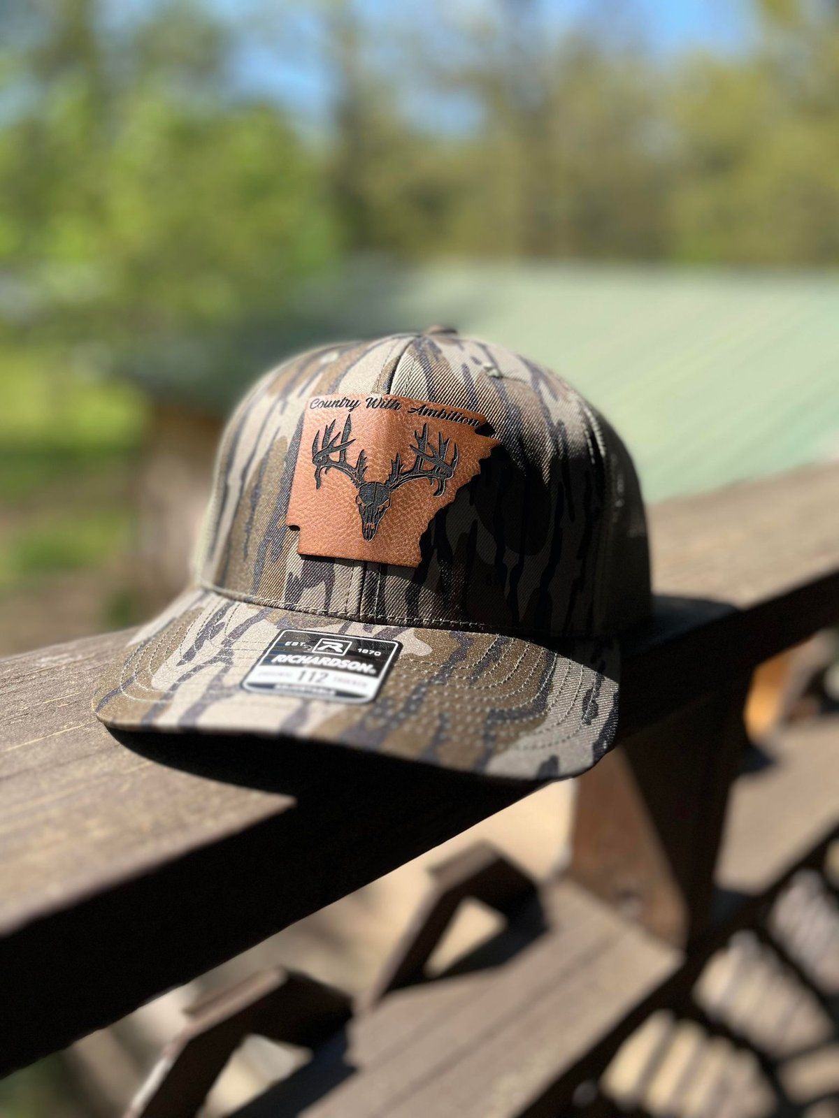 Camo Richardson hat with a leather patch of deer