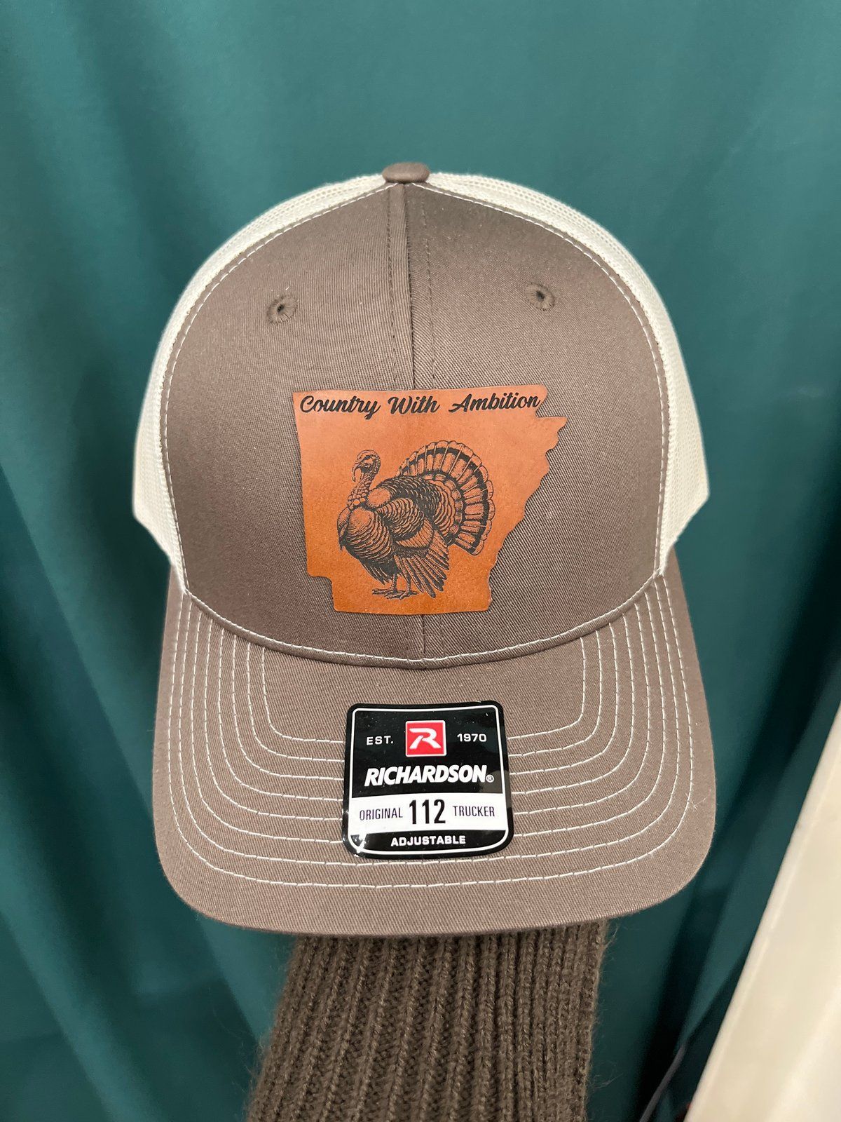 Camouflage trucker hat with Arkansas turkey patch, Richardson 112 tag.