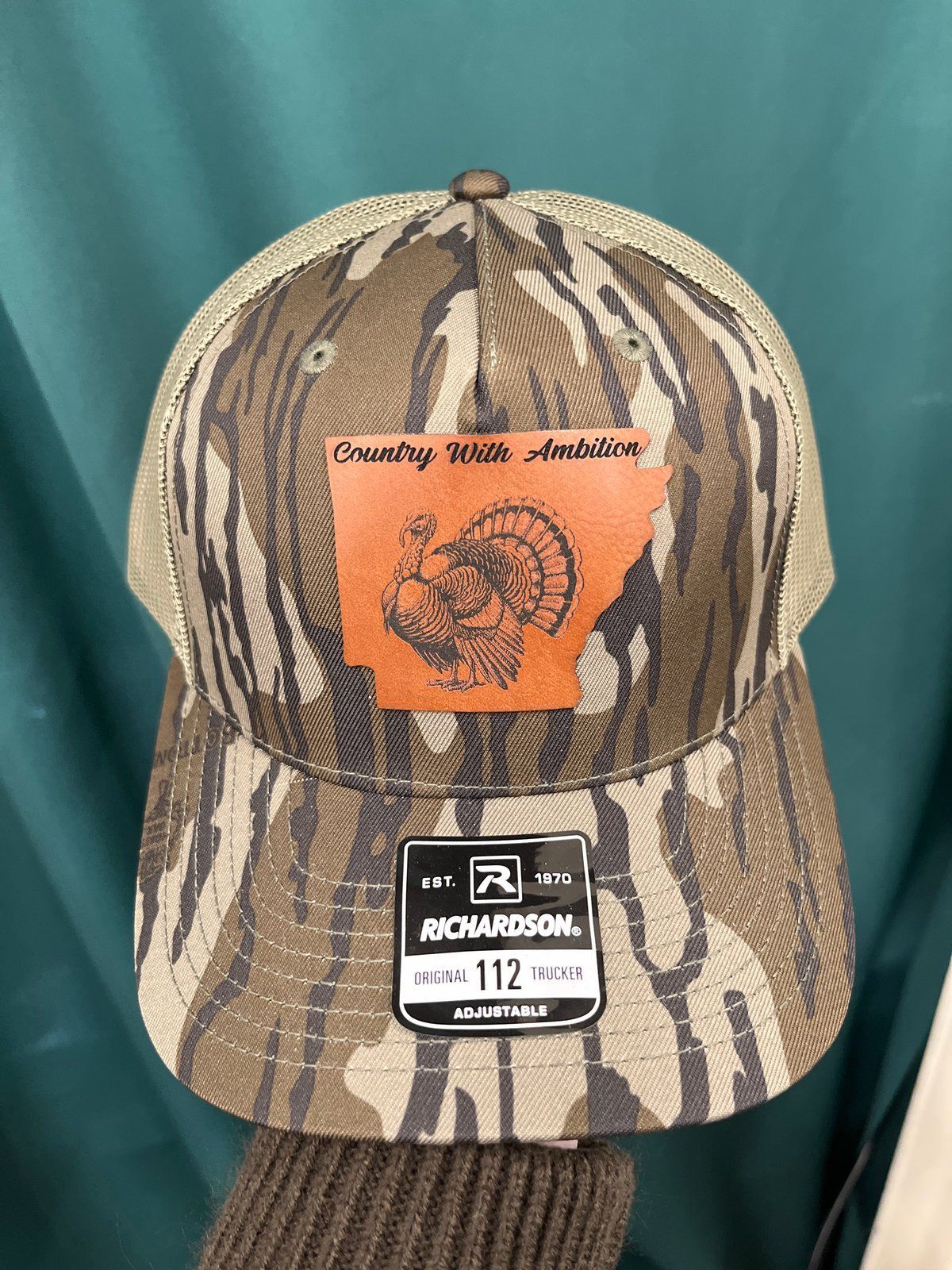 Camouflage trucker hat with Arkansas turkey patch, Richardson 112 tag.