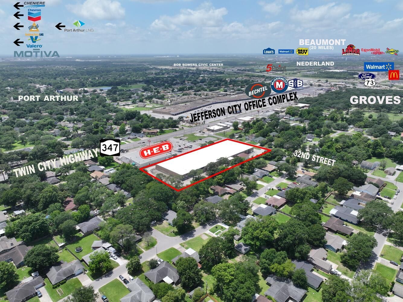 Aerial view of a commercial building with H-E-B in a suburban area, trees surround it, and nearby roads.