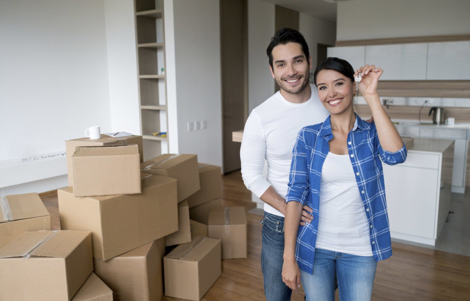 Couple holding keys to their new house