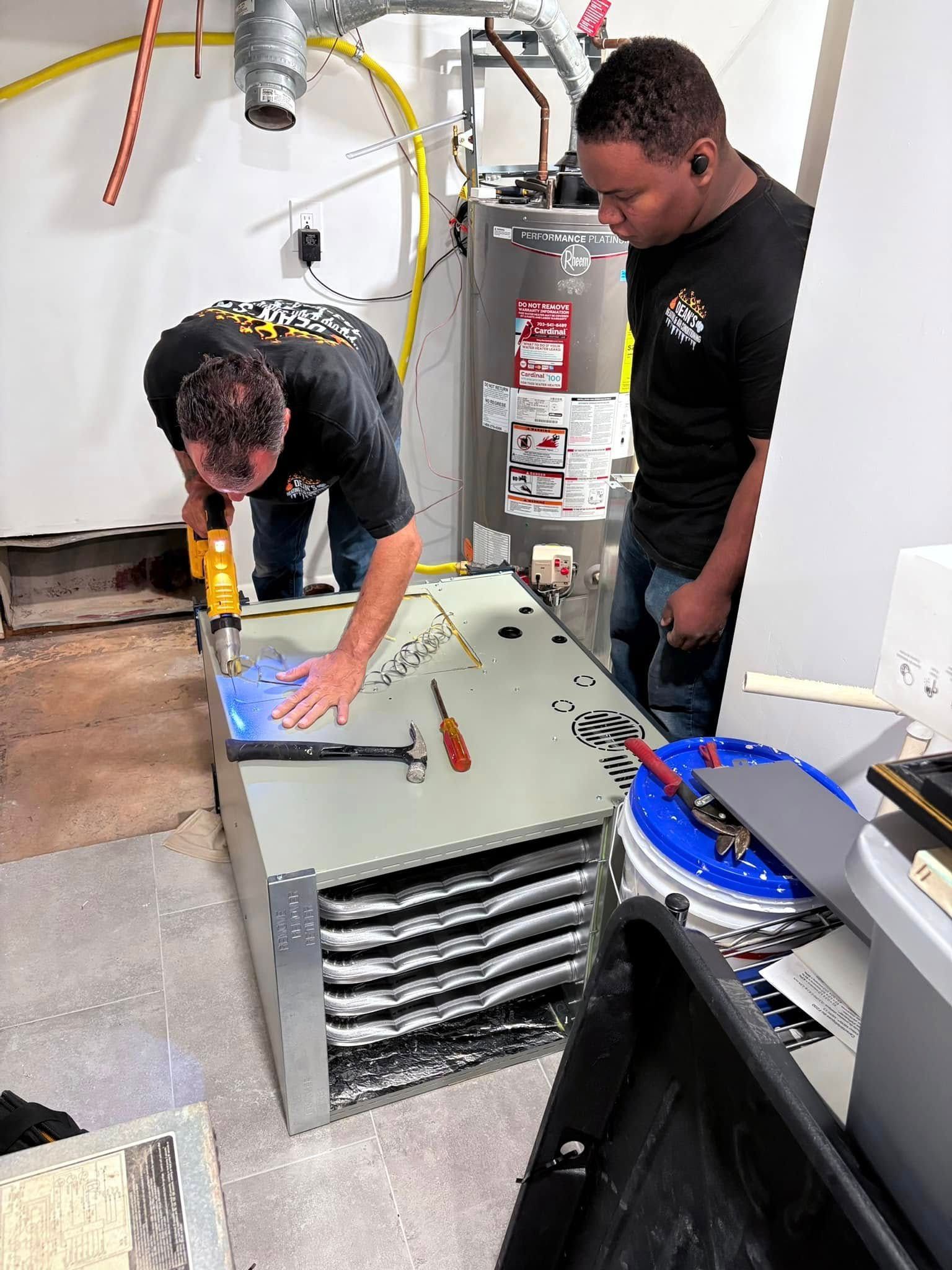 A person is working on an air conditioner with gauges attached to it.