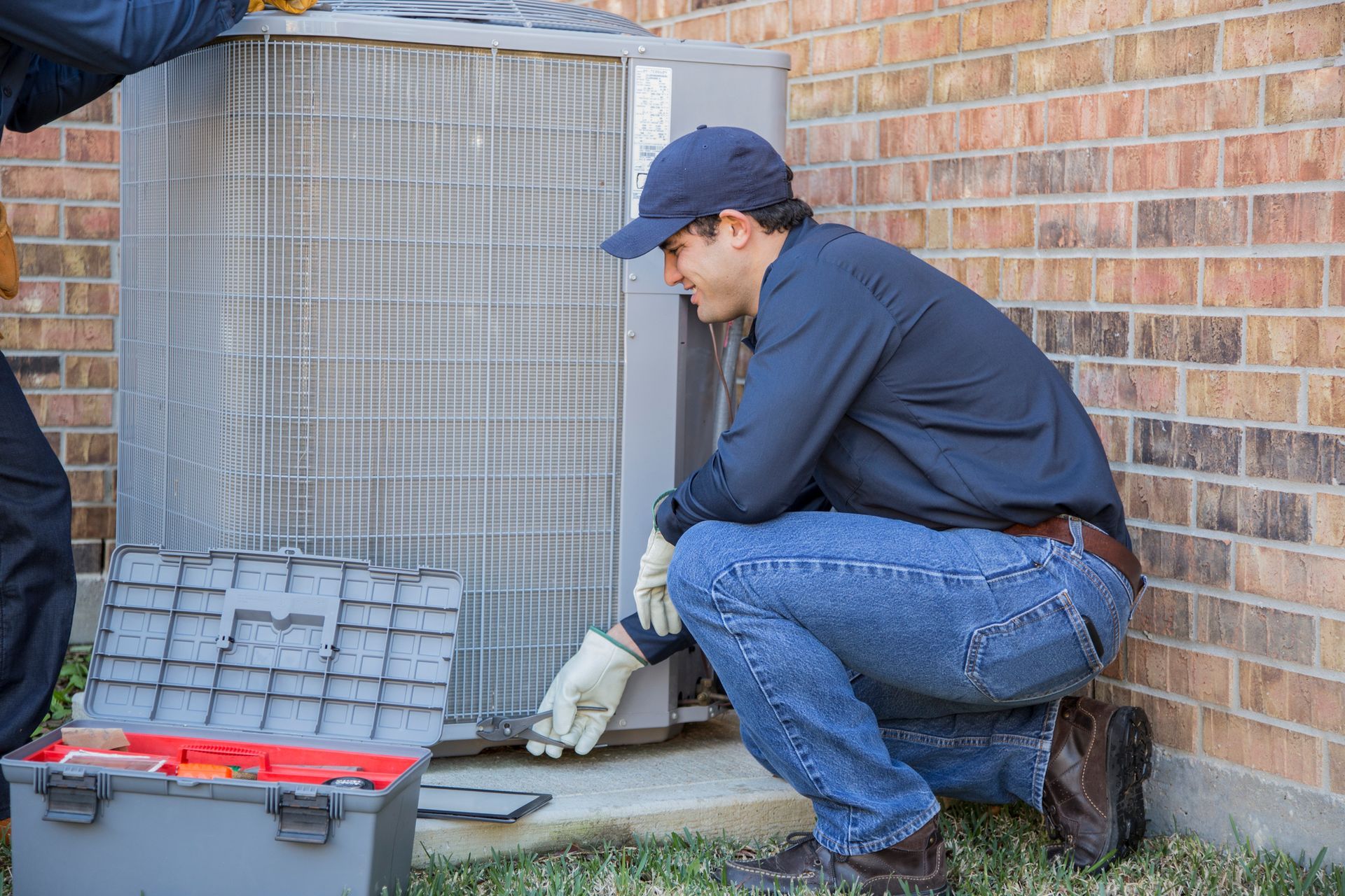 Residential air conditioning repair contractors working on a new AC installation.