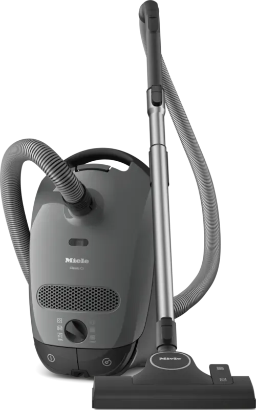 Gray Miele vacuum cleaner with a hose, wand, and floor brush, on a white background.