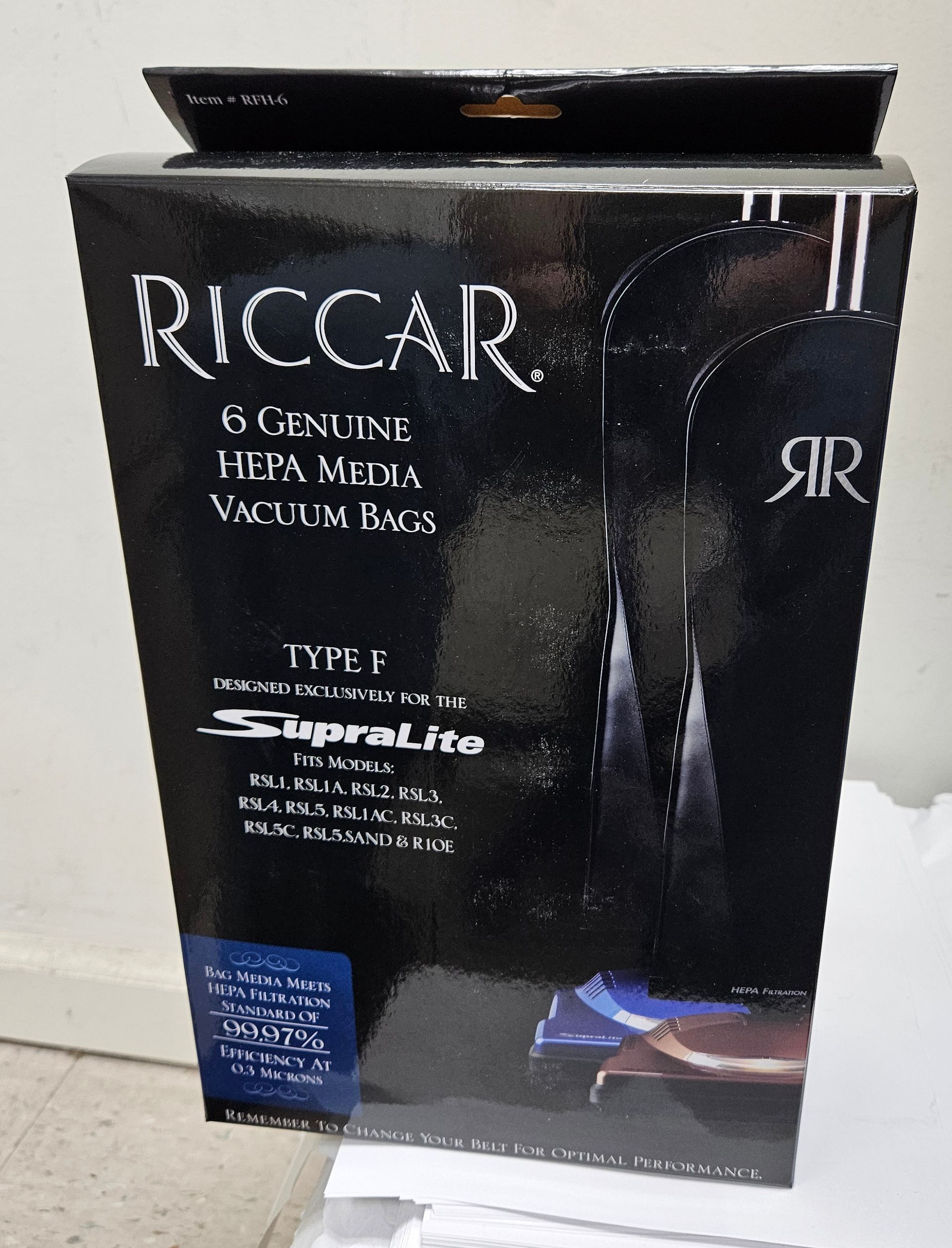 White vacuum cleaner bag with gray plastic mounting plate.