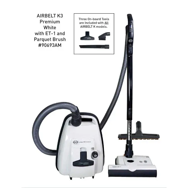 White Airbelt K3 vacuum with attached hose, tools, and upright wand.
