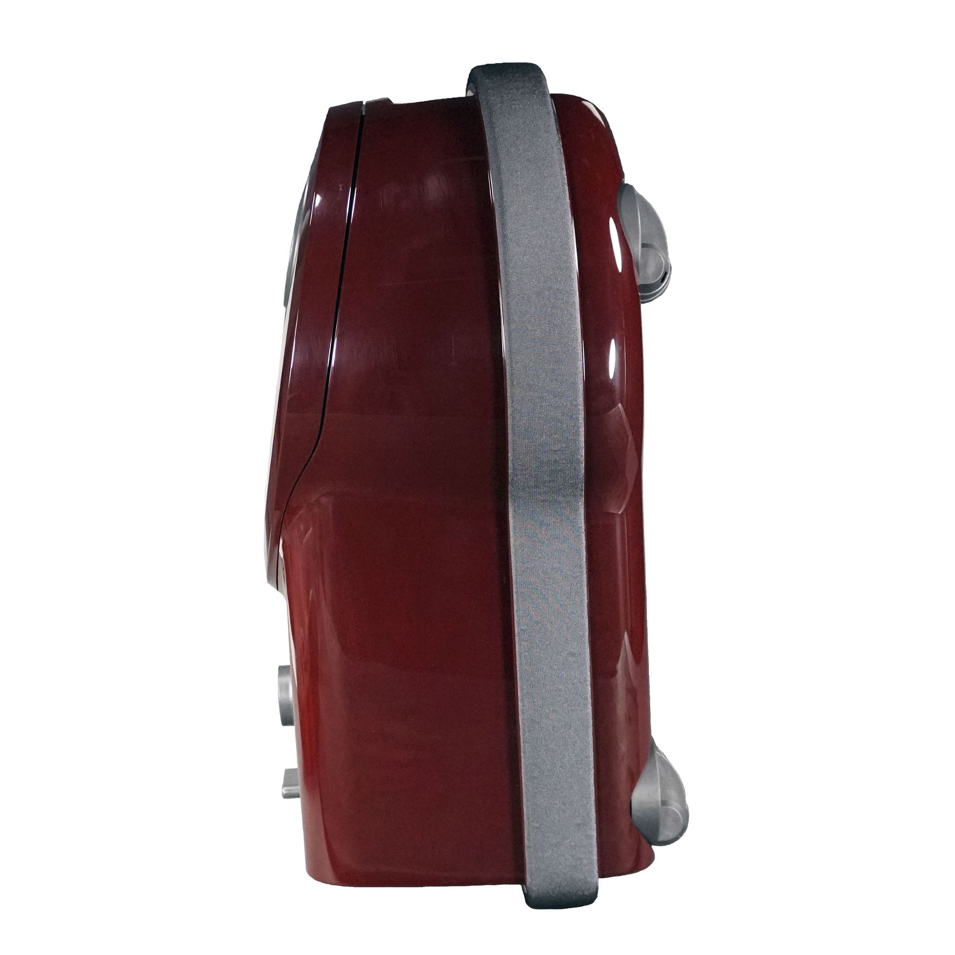 Red canister vacuum cleaner with silver hose and wand, nozzle on floor.