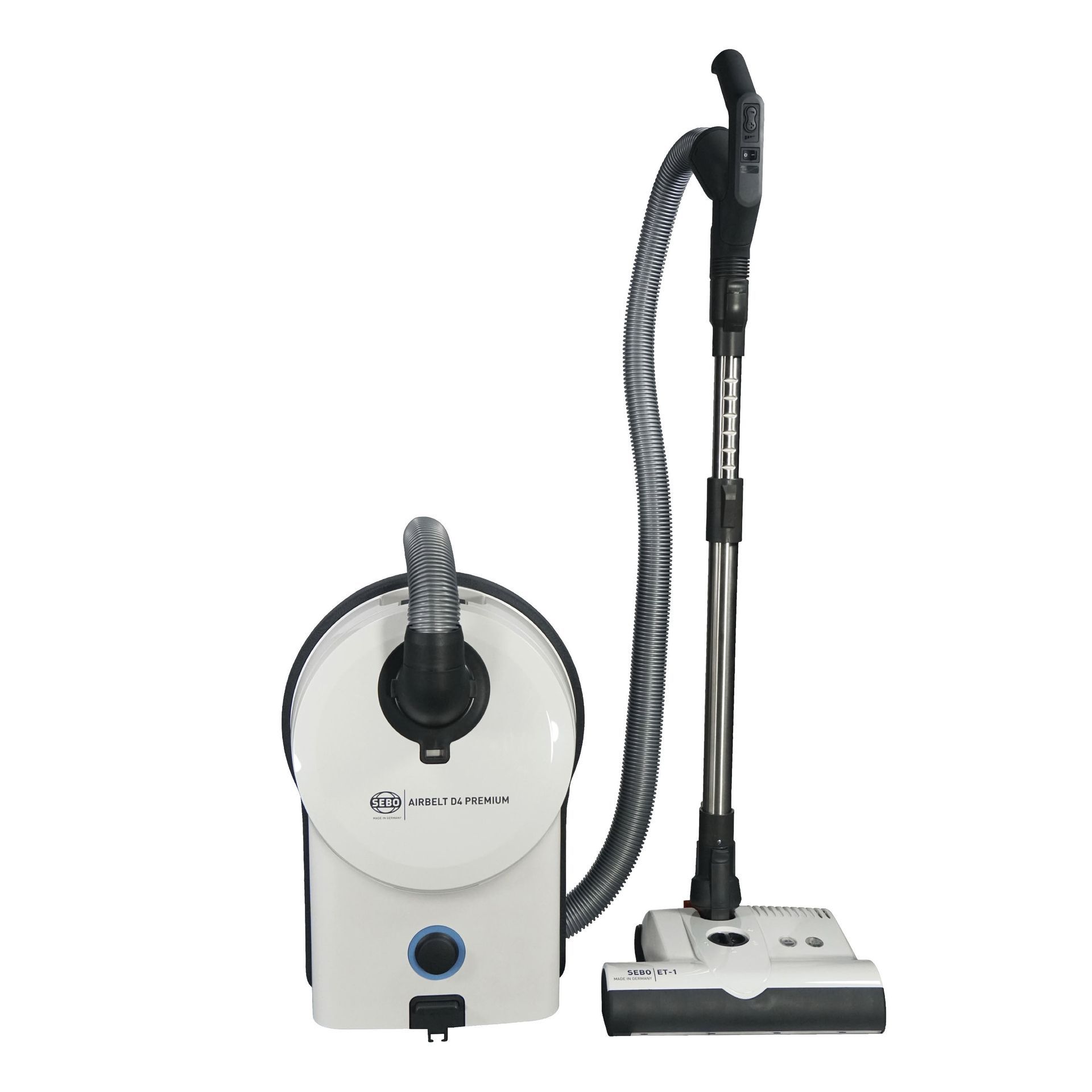 White canister vacuum cleaner with hose, wand, and floor brush.
