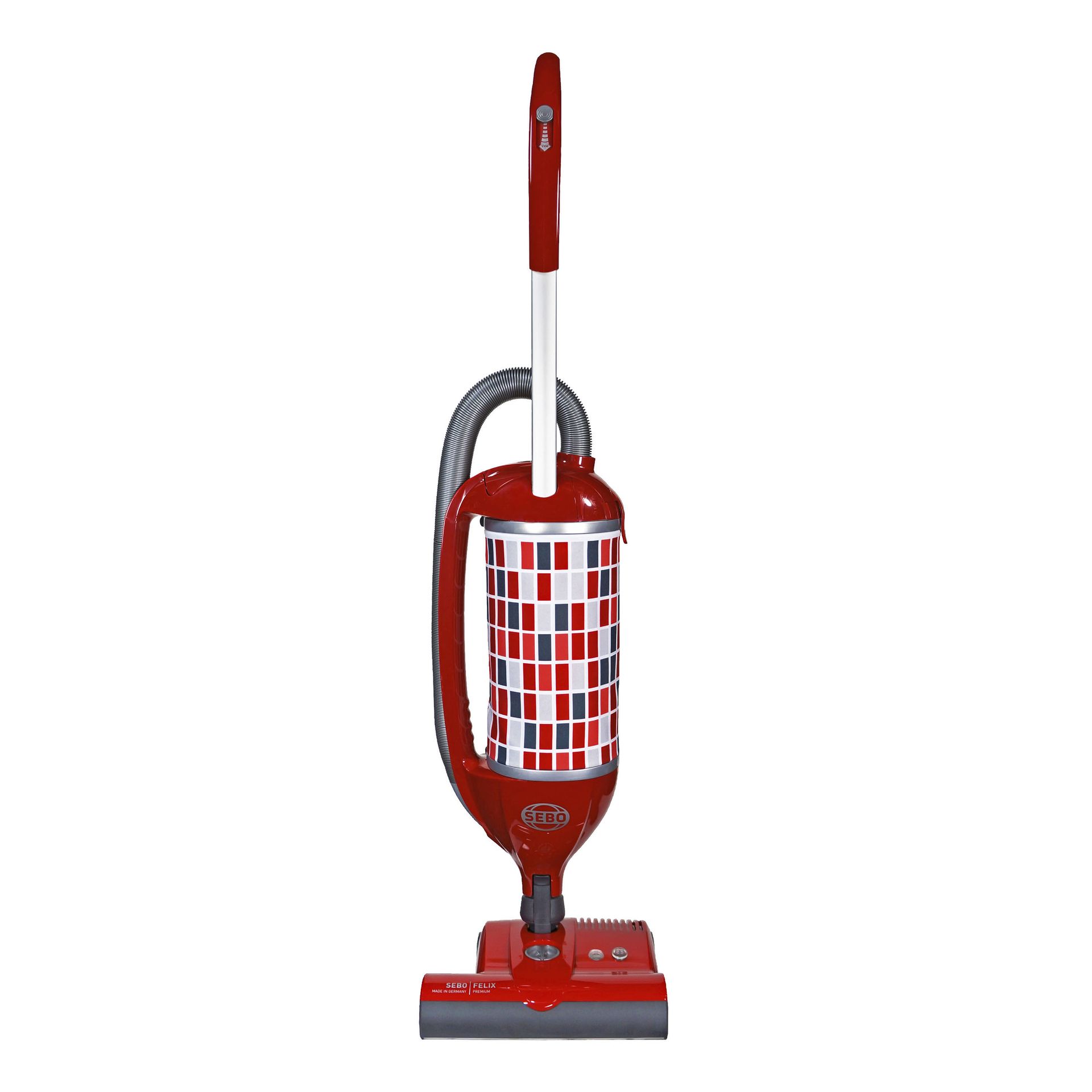 Red upright vacuum cleaner with a patterned canister.