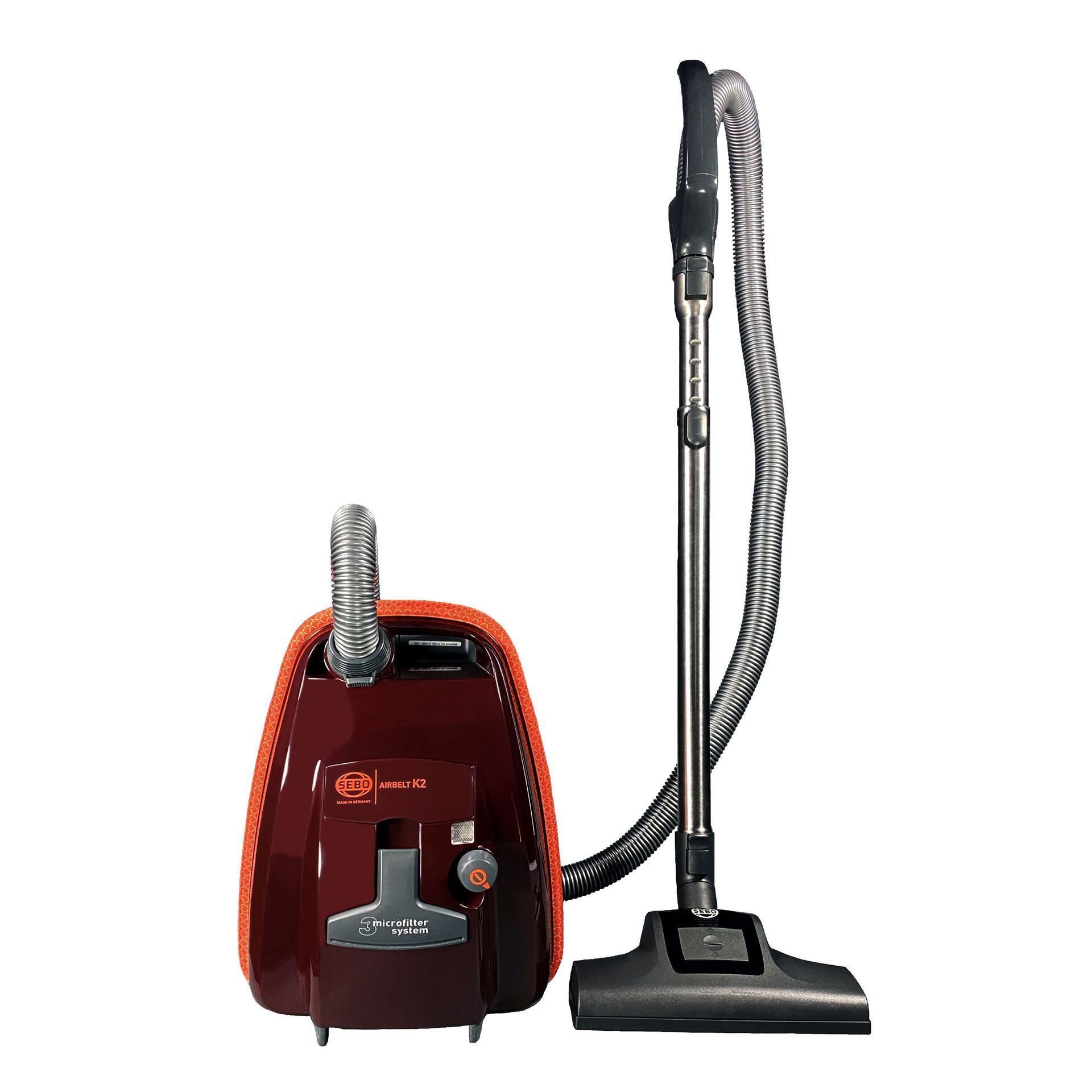 A burgundy canister vacuum with a silver wand and black floor brush, set on a white background.