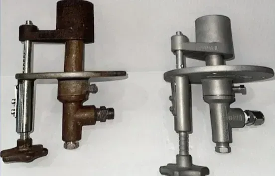 Two pieces of metal are sitting next to each other on a white surface.