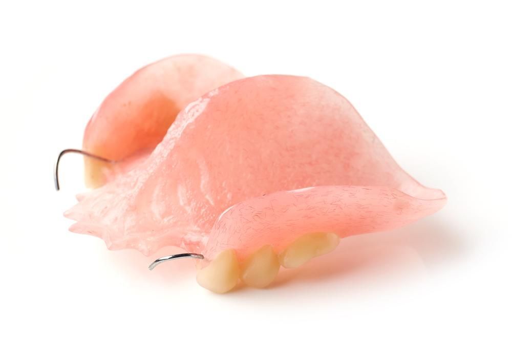A Close up Of a Denture on A White Background — Cosmetic Denture Services–Jacob Maxwell in Moranbah, QLD