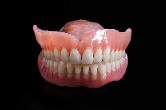 Close Up of a Person 's Teeth on a Black Background — Cosmetic Denture Services–Jacob Maxwell in Mackay, QLD