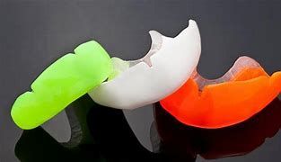 A Model of A Mouth with Braces and A Mouth Guard — Cosmetic Denture Services–Jacob Maxwell in Mackay, QLD