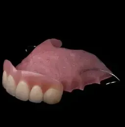 Close Up of a Denture on a Black Background — Cosmetic Denture Services–Jacob Maxwell in Proserpine, QLD