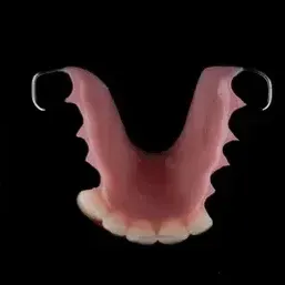 Close Up of a Denture on a Black Background — Cosmetic Denture Services–Jacob Maxwell in Proserpine, QLD