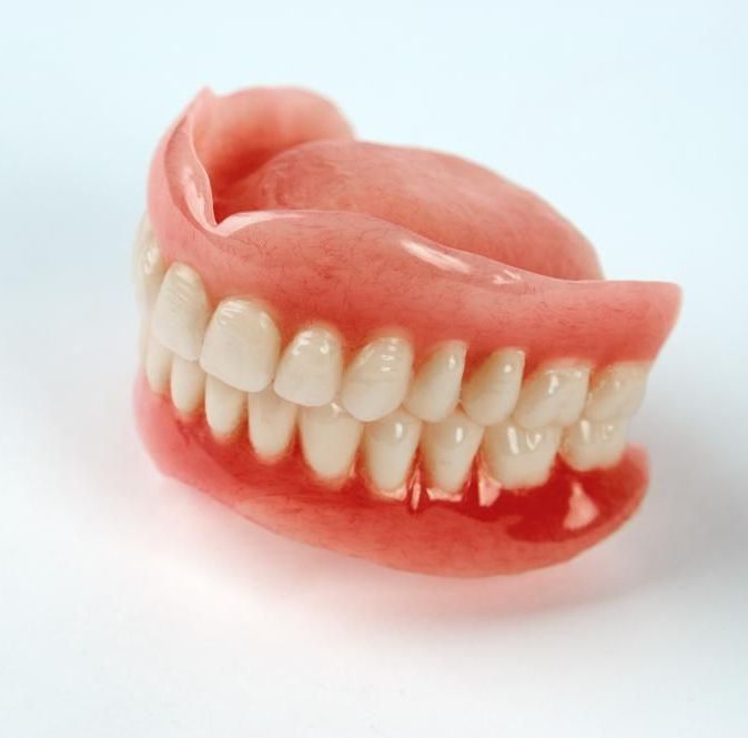 A Close up Of a Denture on A White Surface — Cosmetic Denture Services–Jacob Maxwell in Sarina, QLD