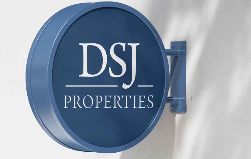 Blue round DSJ Properties wall sign on a bracket against a white background