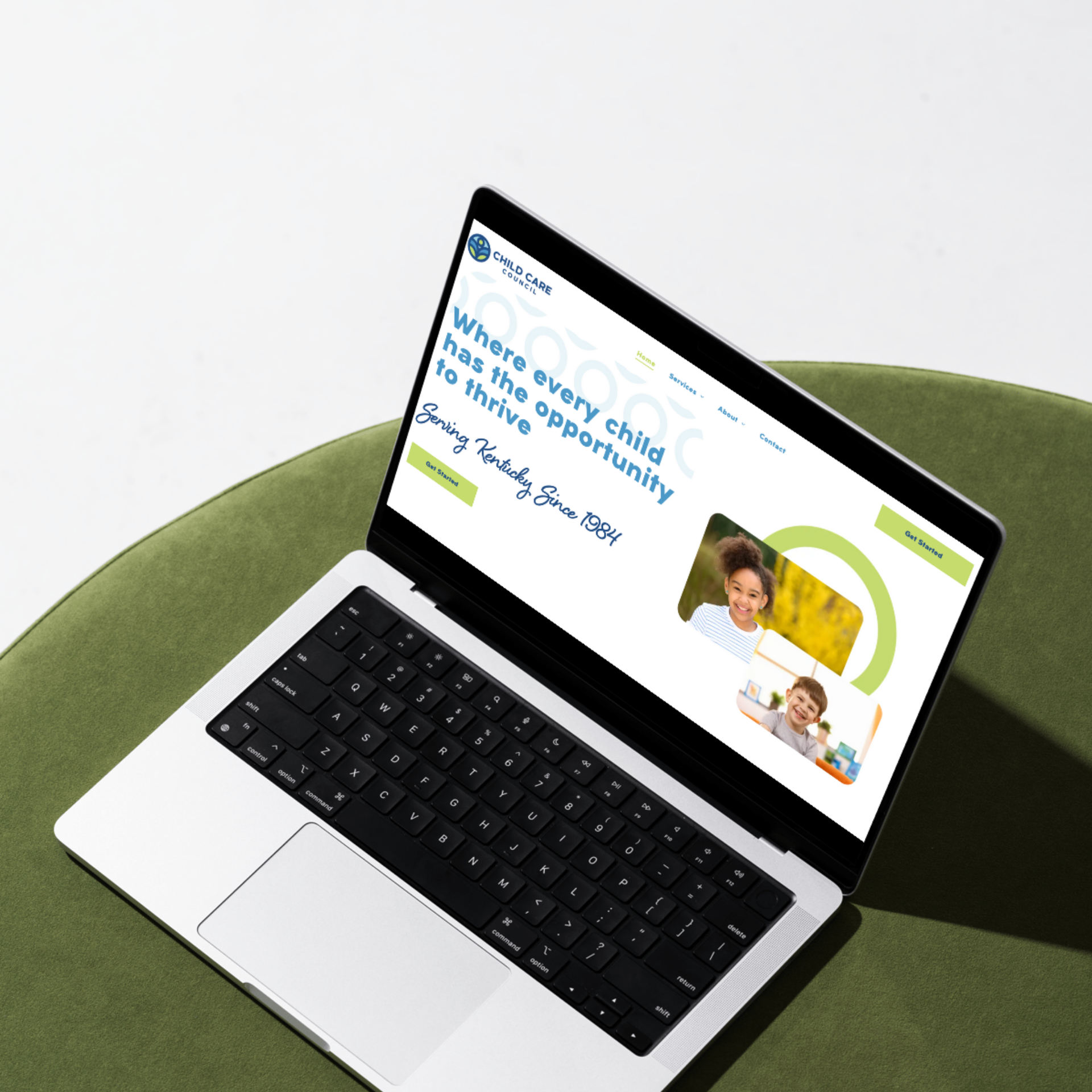Open laptop with black keyboard and a colorful website on the screen, viewed from above