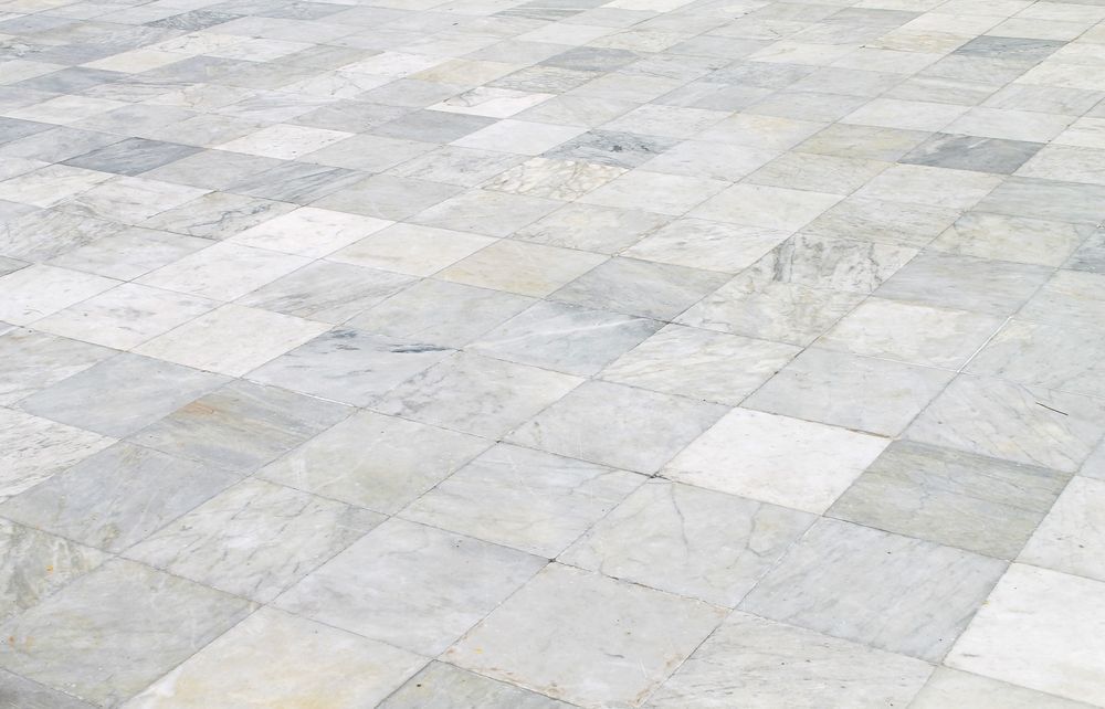 A close up of a white tiled floor with a checkered pattern — Port Stephens Bathrooms In Hamilton, NSW