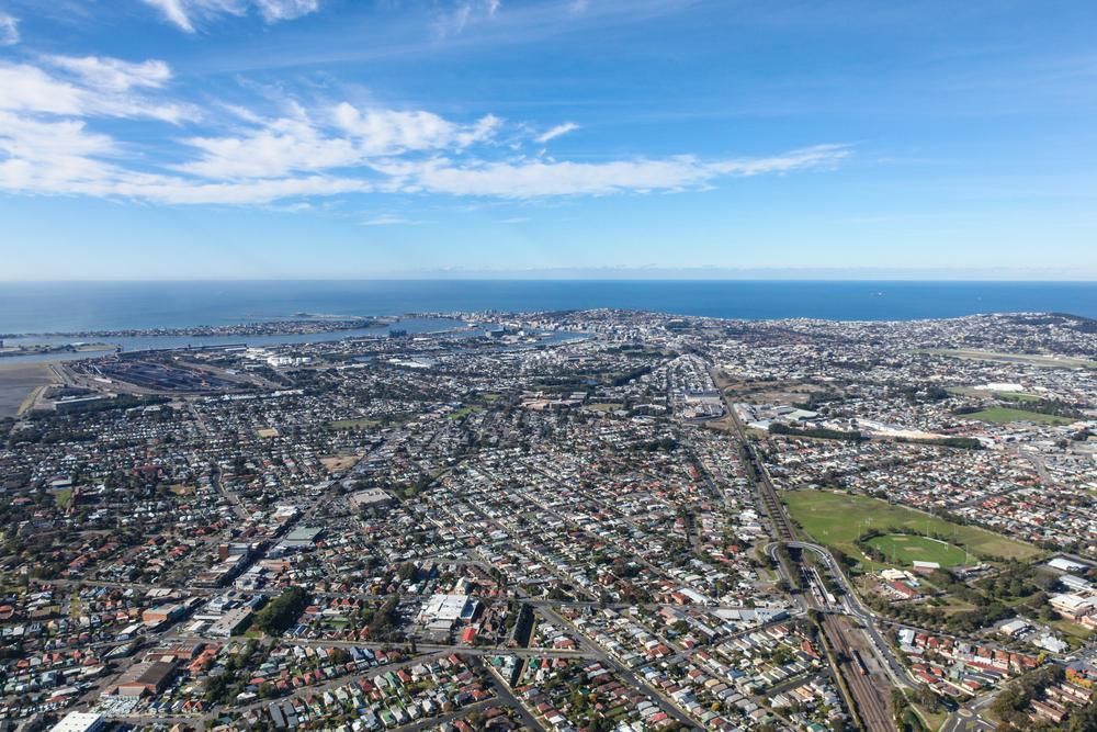 an Aerial View of a City With the Ocean in the Background — Port Stephens Bathrooms In Hamilton, NSW