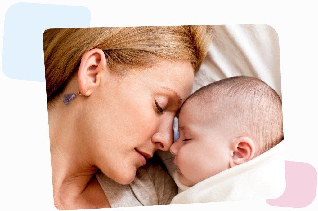 happy mom sleeping with her newborn baby