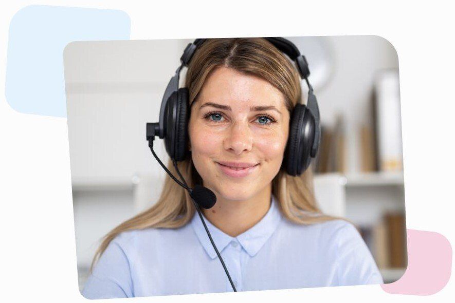 female phone consultant with headphones and a microphone looking at the camera and smiling