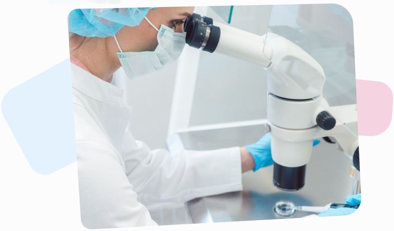 ivf specialist using a microscope on an embryo cells