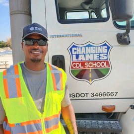 student standing in front of truck
