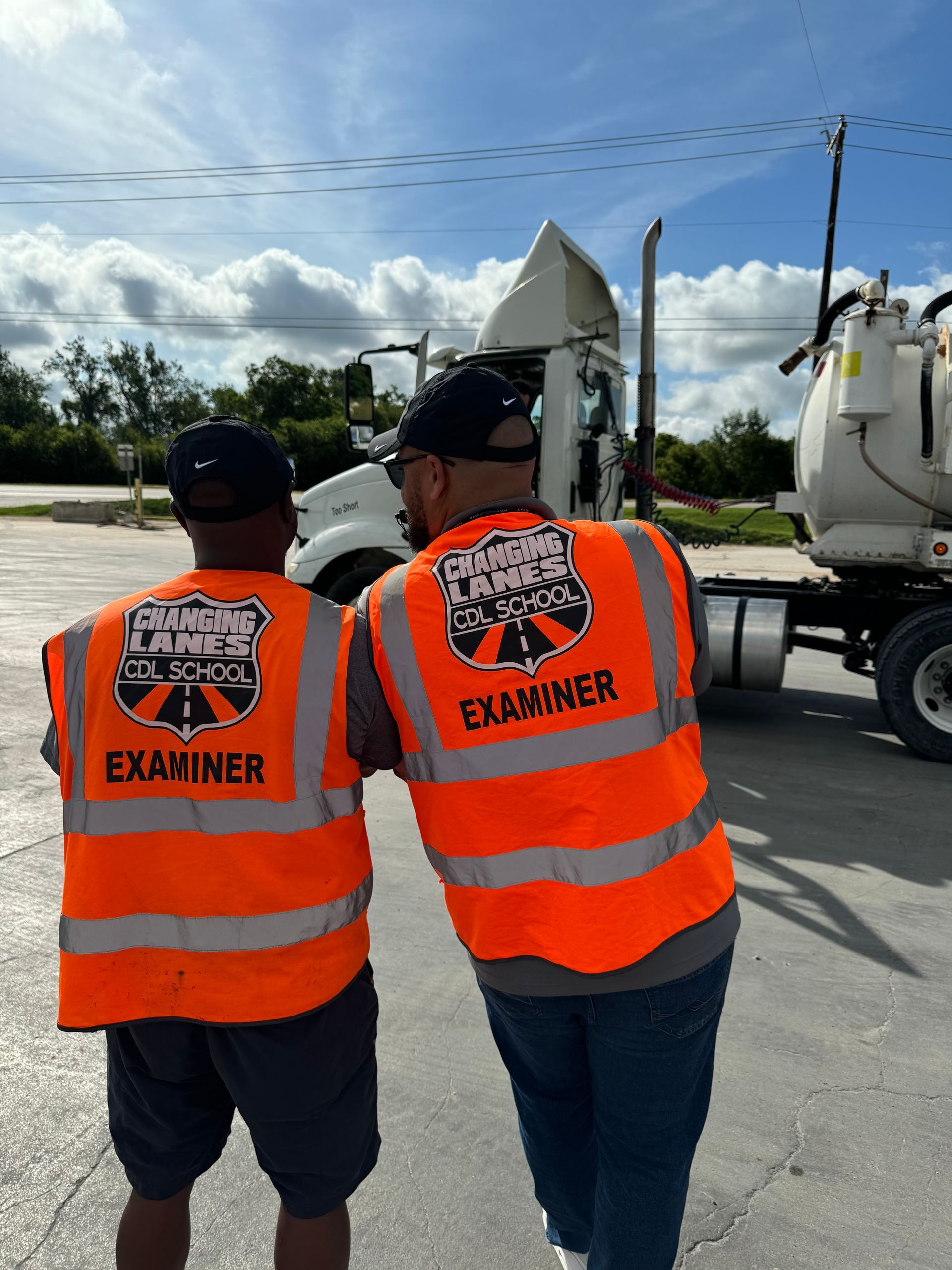 A man is standing in front of a changing lanes truck