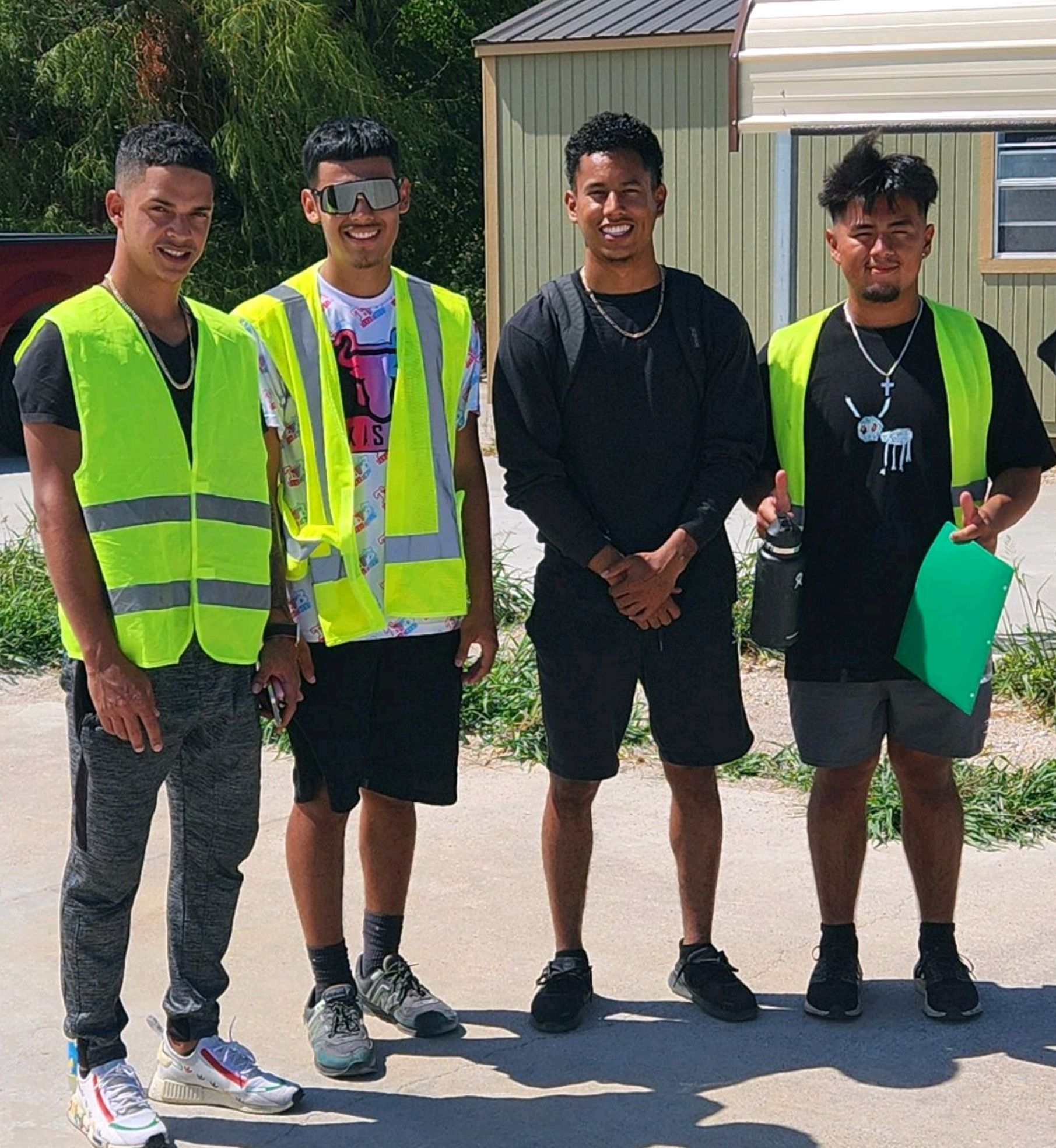 A row of semi trucks are parked in a parking lot.