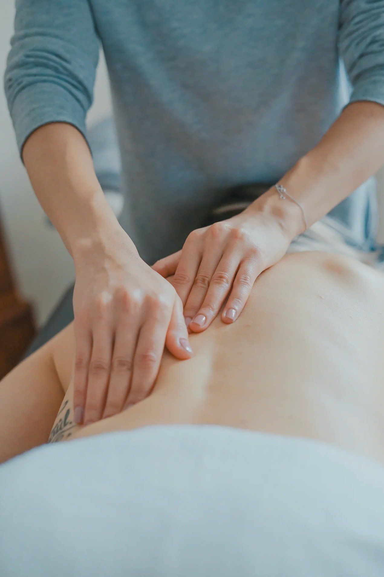 A person is giving a massage to another person.