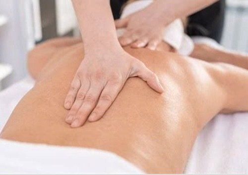 A person is getting a massage on their back at a spa.