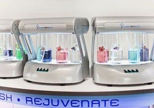 Three rejuvenate machines are lined up on a counter